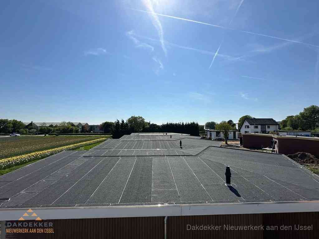 Groot plat dak met bitumen dakbedekking op bedrijfspand in Nieuwerkerk aan den IJssel